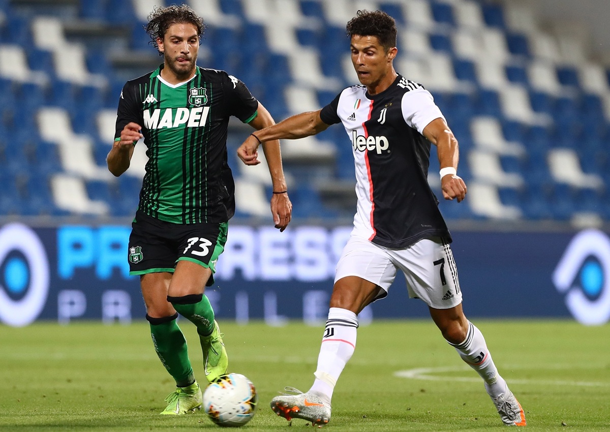 Giocatore della Juventus e calciatore del Sassuolo si contendono il pallone durante una partita di Serie A