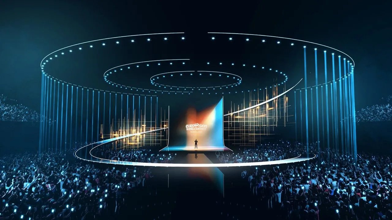 Palco futuristico dell’Eurovision Song Contest 2026 con pubblico e luci LED blu